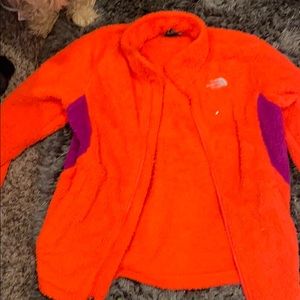 Orange and purple north face jacket